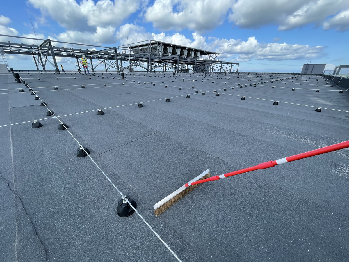 ELD high-voltage inspection — technician sweeping